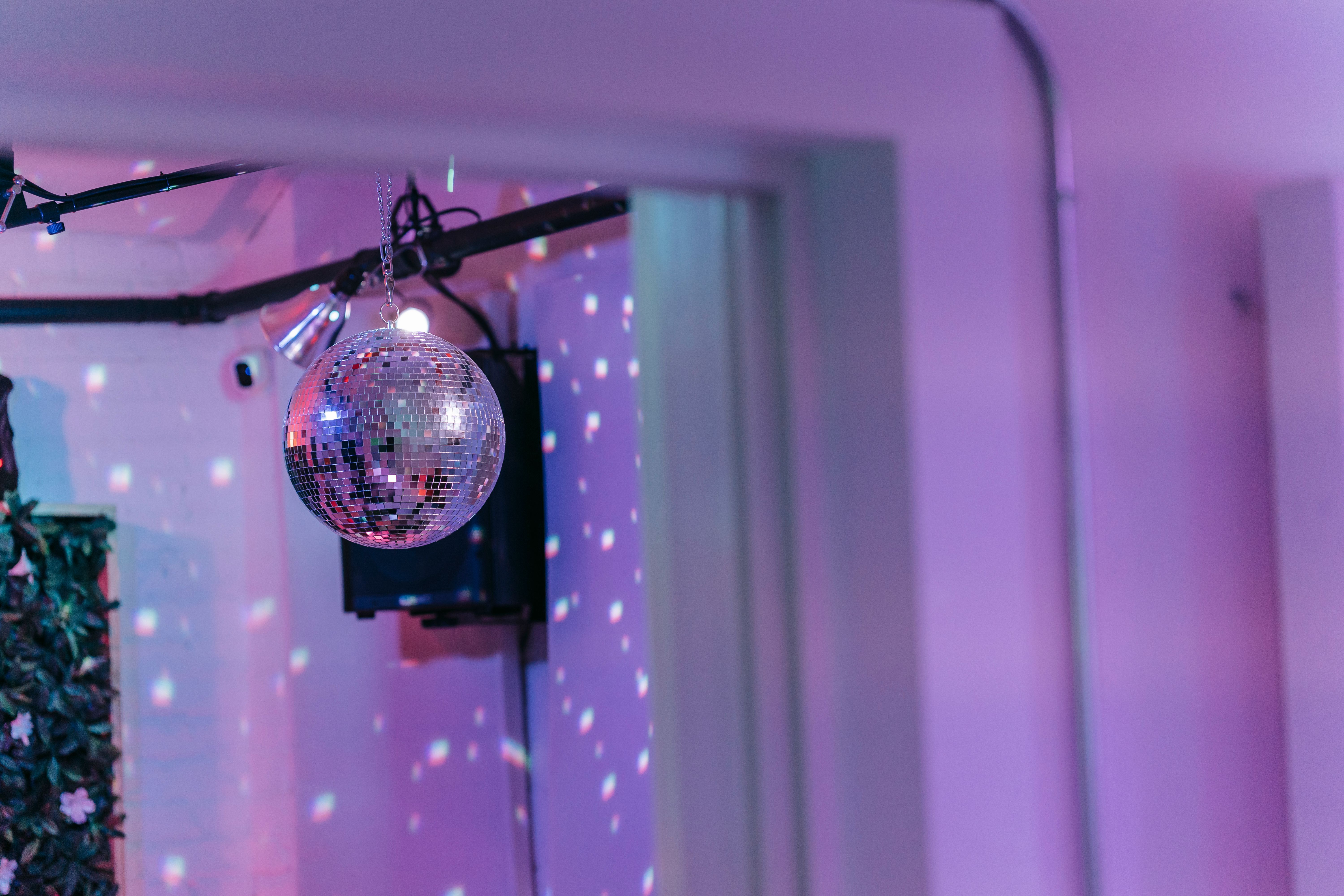 A disco ball hanging in a kitchen, scattering light around the room.