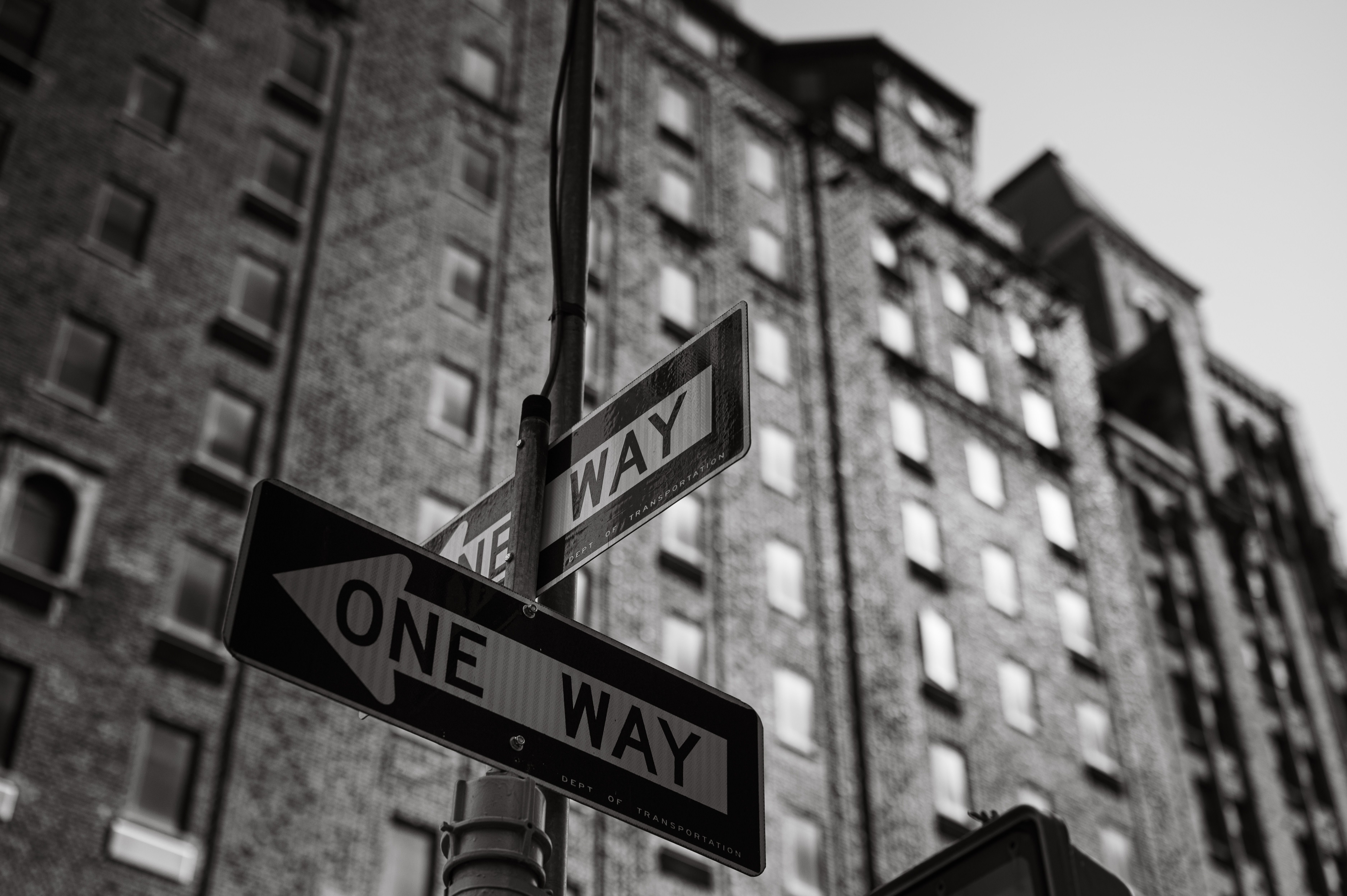 Street signs pointing in different directions at a city intersection.