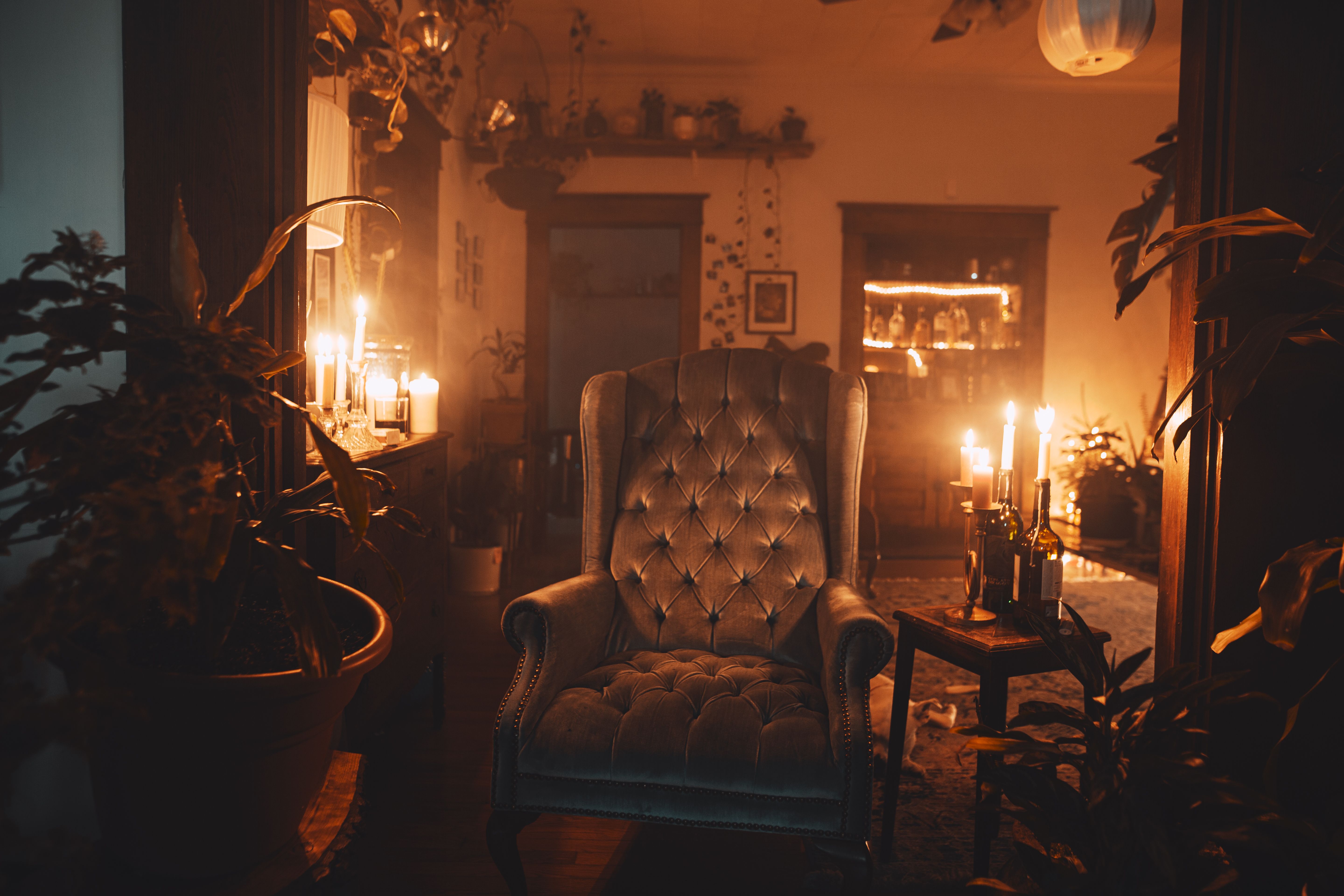 empty armchair warm light night book headphones
