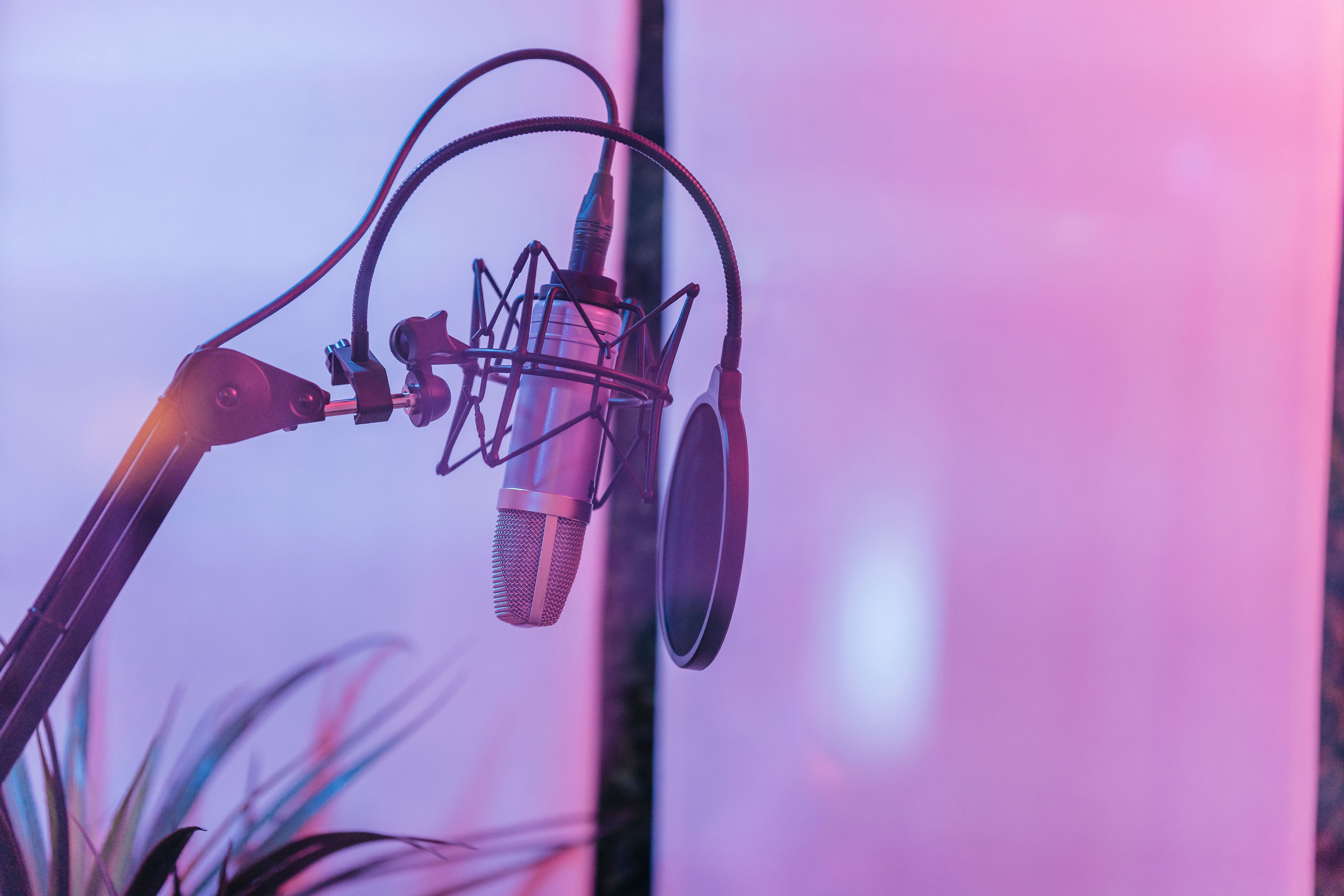 Studio microphone in a warmly lit recording space.